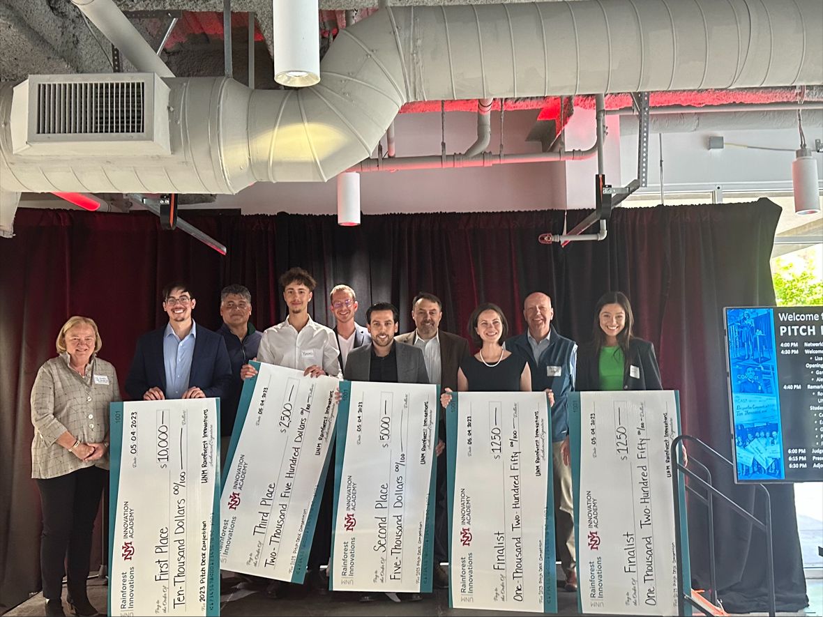 photo: pitch presentation winners with giant checks.
